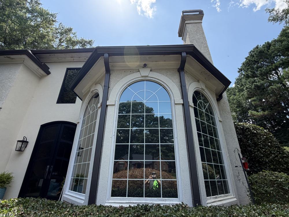 Arched bay windows on a white stucco home