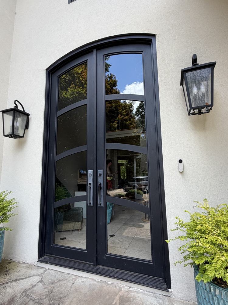 Arched black French doors with clear glass