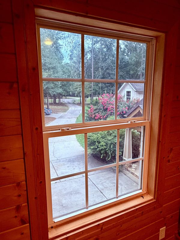 Before: a double-hung window with streaks and film across the glass