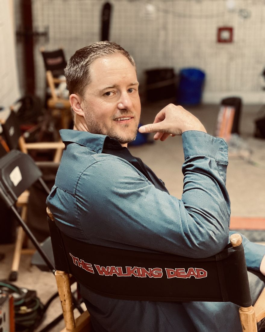 Ryan Olson, owner of TruPro Window Cleaning, sitting in a The Walking Dead director's chair on set